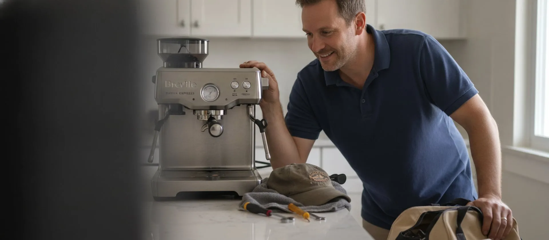 Breville Barista Express on a kitchen counter, technician leaning in to look at the group head; cap and tools on a towel